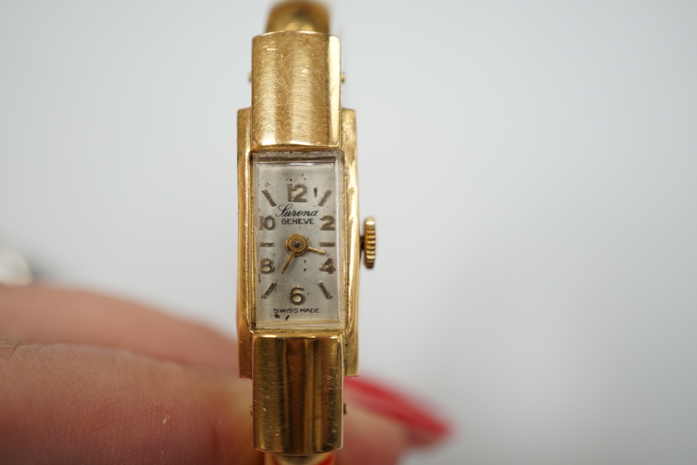 A George V silver pocket watch with arabic dial, 3.25cm, a gentleman's gold plated Omega Automatic wrist watch with loose bracelet, a gun metal dress watch and a Surena gold overlaid cocktail watch